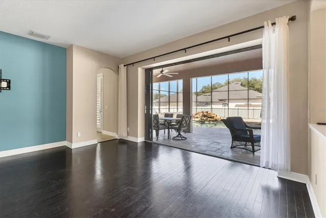 a view of a kitchen with furniture and wooden floor