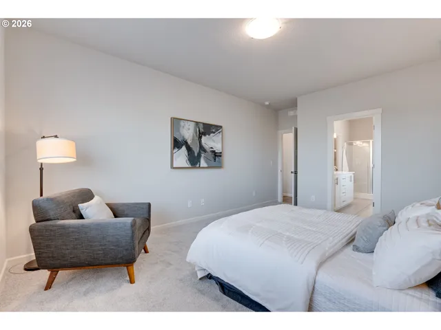 a bedroom with furniture and a lamp