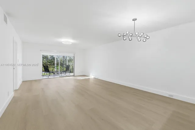 an empty room with a empty space and windows