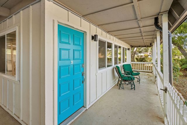 a balcony with table and chairs