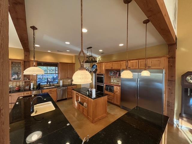 306 Charles Road Kerrville, TX 78028 - Photo 14 of 50 a kitchen with stainless steel appliances kitchen island granite countertop a refrigerator a stove and a sink with wooden floor