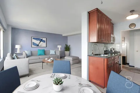 a living room with furniture a dining table and chairs