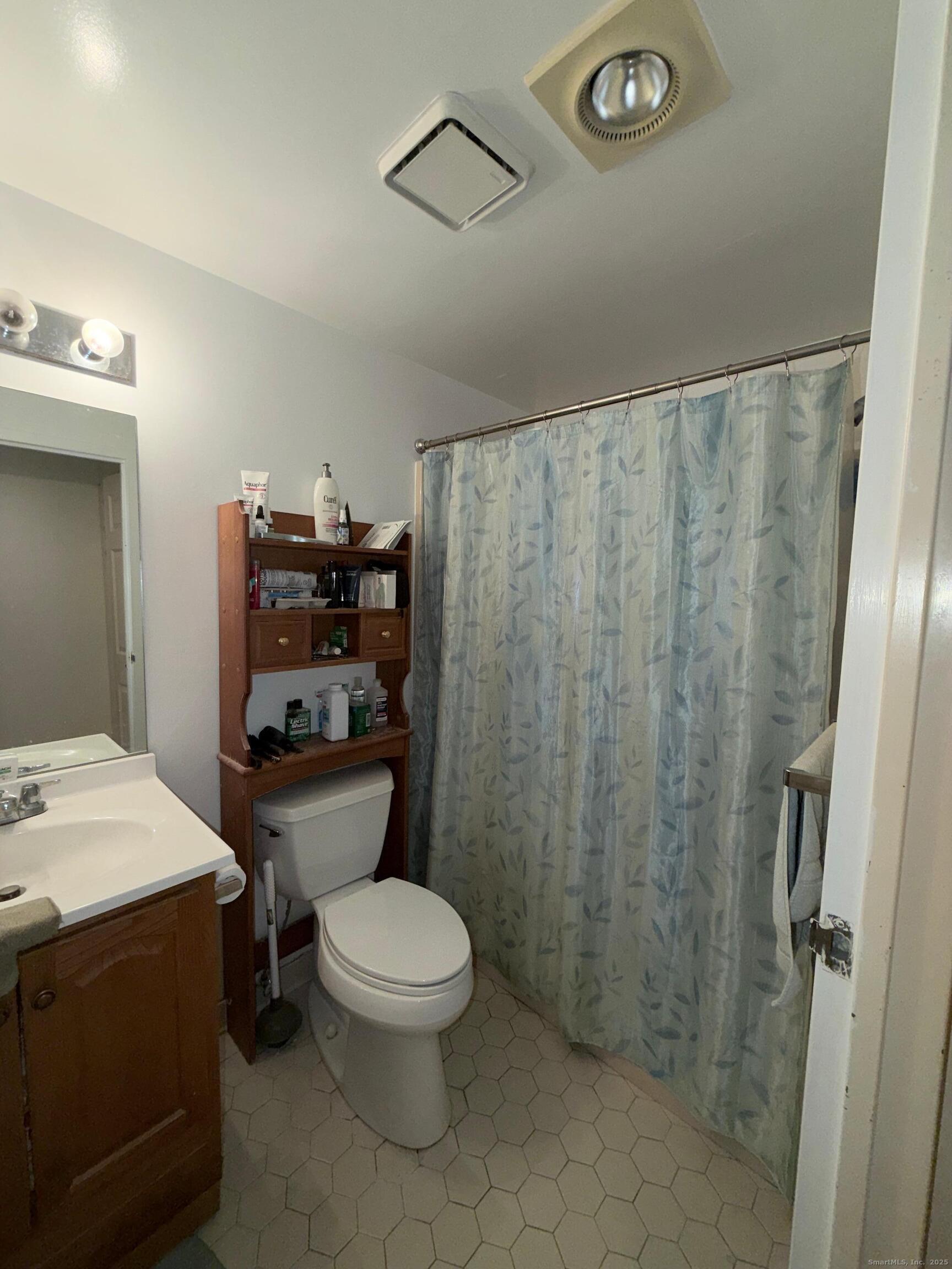 850 Atlantic Street, Unit 208 Bridgeport, CT 06604 - Photo 14 of 16 a white toilet sitting next to a bathroom sink