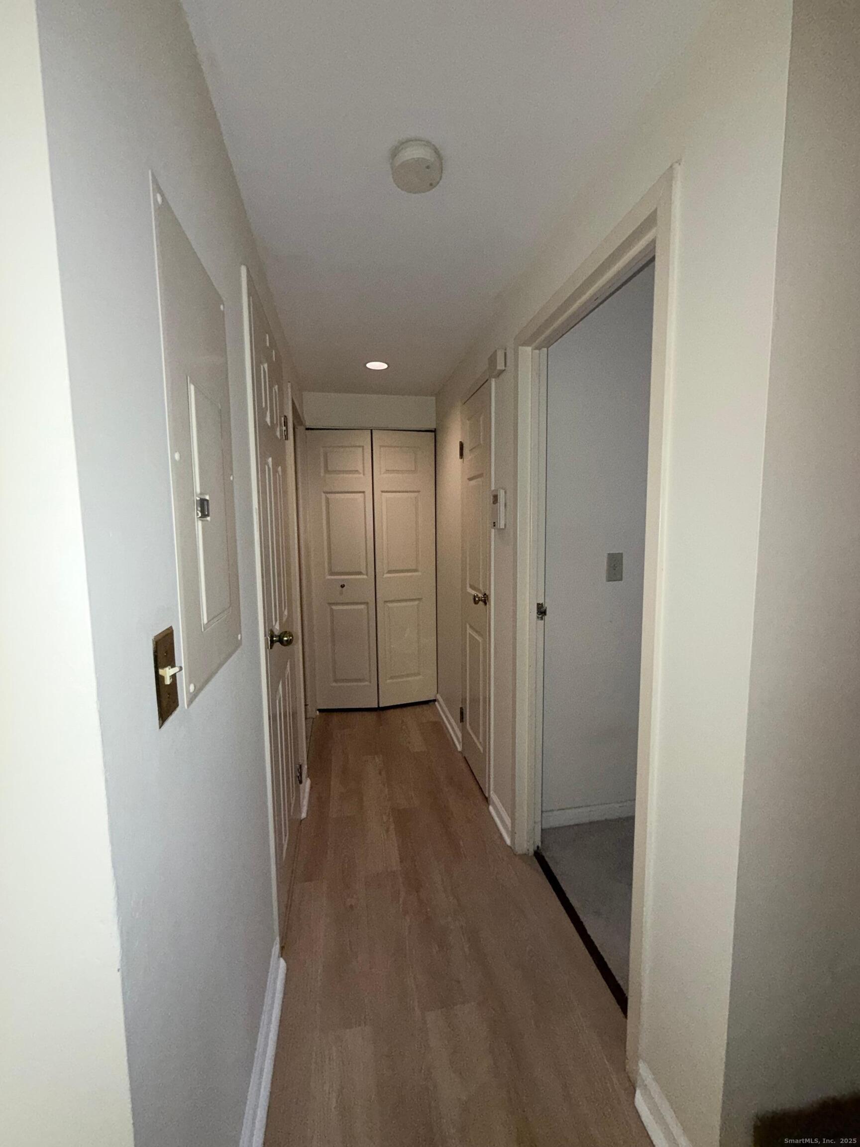 850 Atlantic Street, Unit 208 Bridgeport, CT 06604 - Photo 6 of 16 a view of a hallway with wooden floor