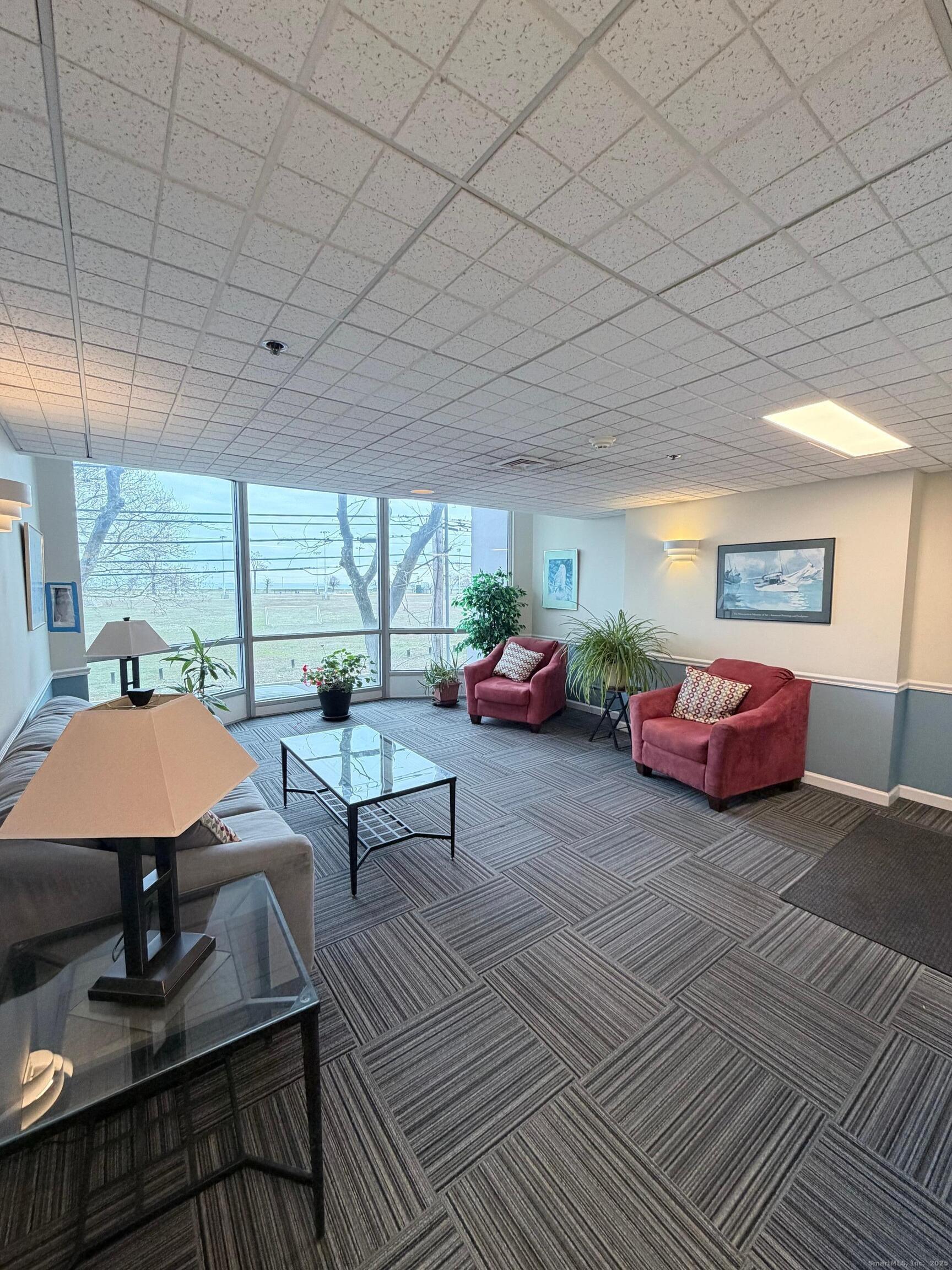 850 Atlantic Street, Unit 208 Bridgeport, CT 06604 - Photo 7 of 16 a living room with furniture a table and a large window