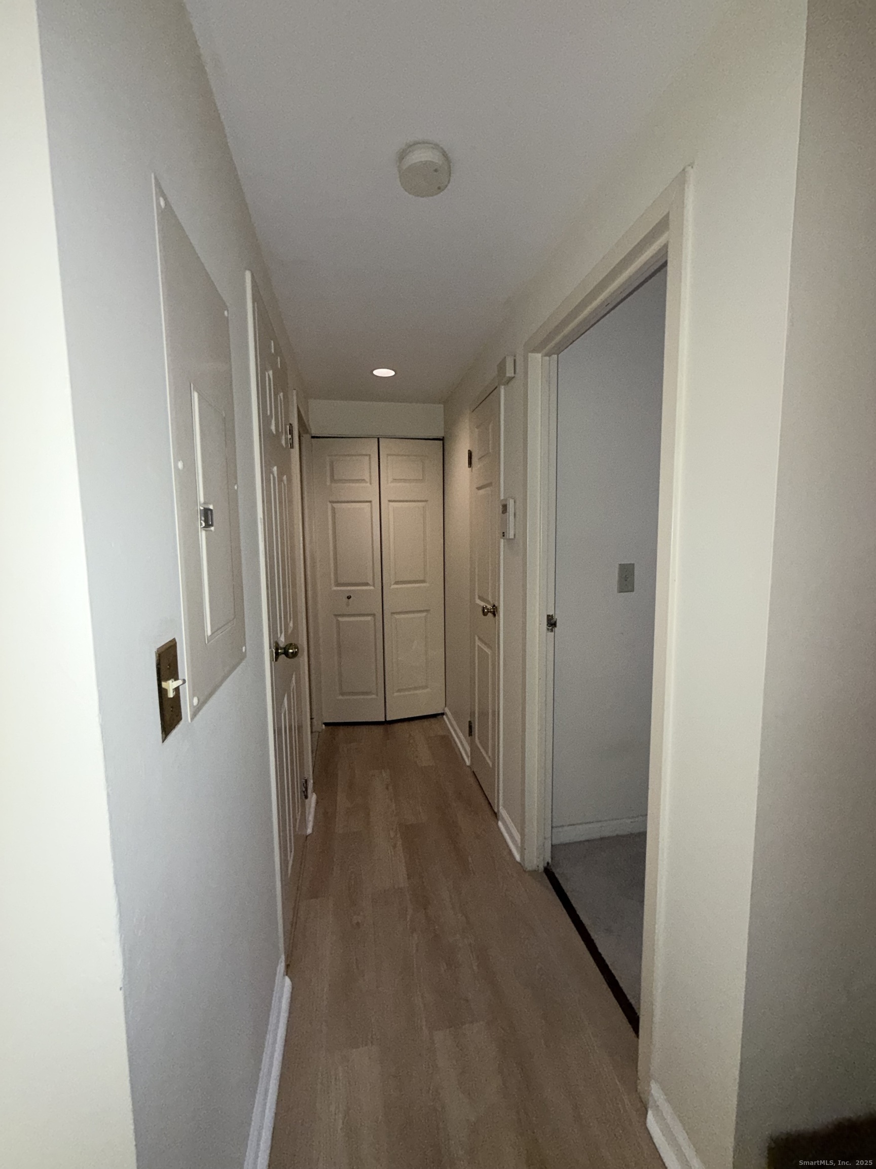 850 Atlantic Street, Unit 208 Bridgeport, CT 06604 - Photo 9 of 16 a view of a hallway with wooden floor