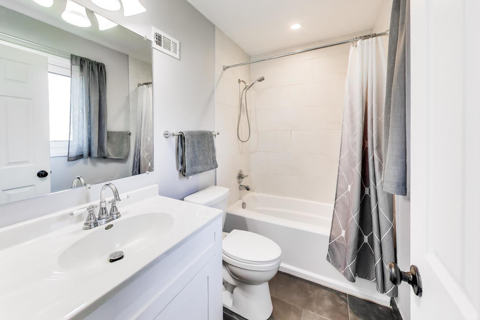 420 Bode Road Hoffman Estates, IL 60169 - Photo 10 of 20 a bathroom with a sink toilet tub and shower