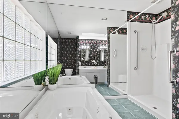 a white bath tub sitting in front of a shower