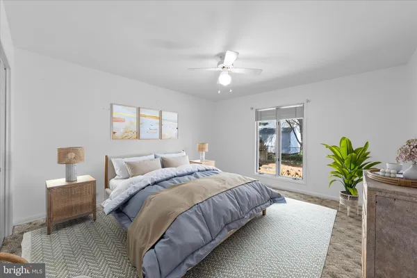 a bedroom with bed and a potted plant