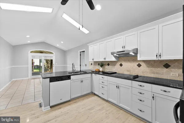 a kitchen with sink and cabinets