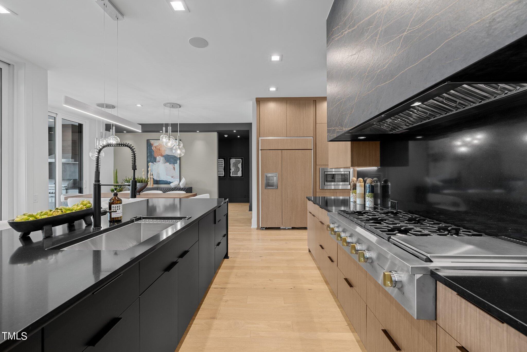1711 Hunting Ridge Road Raleigh, NC 27615 - Photo 13 of 62 a large kitchen with stainless steel appliances lots of counter space and a sink