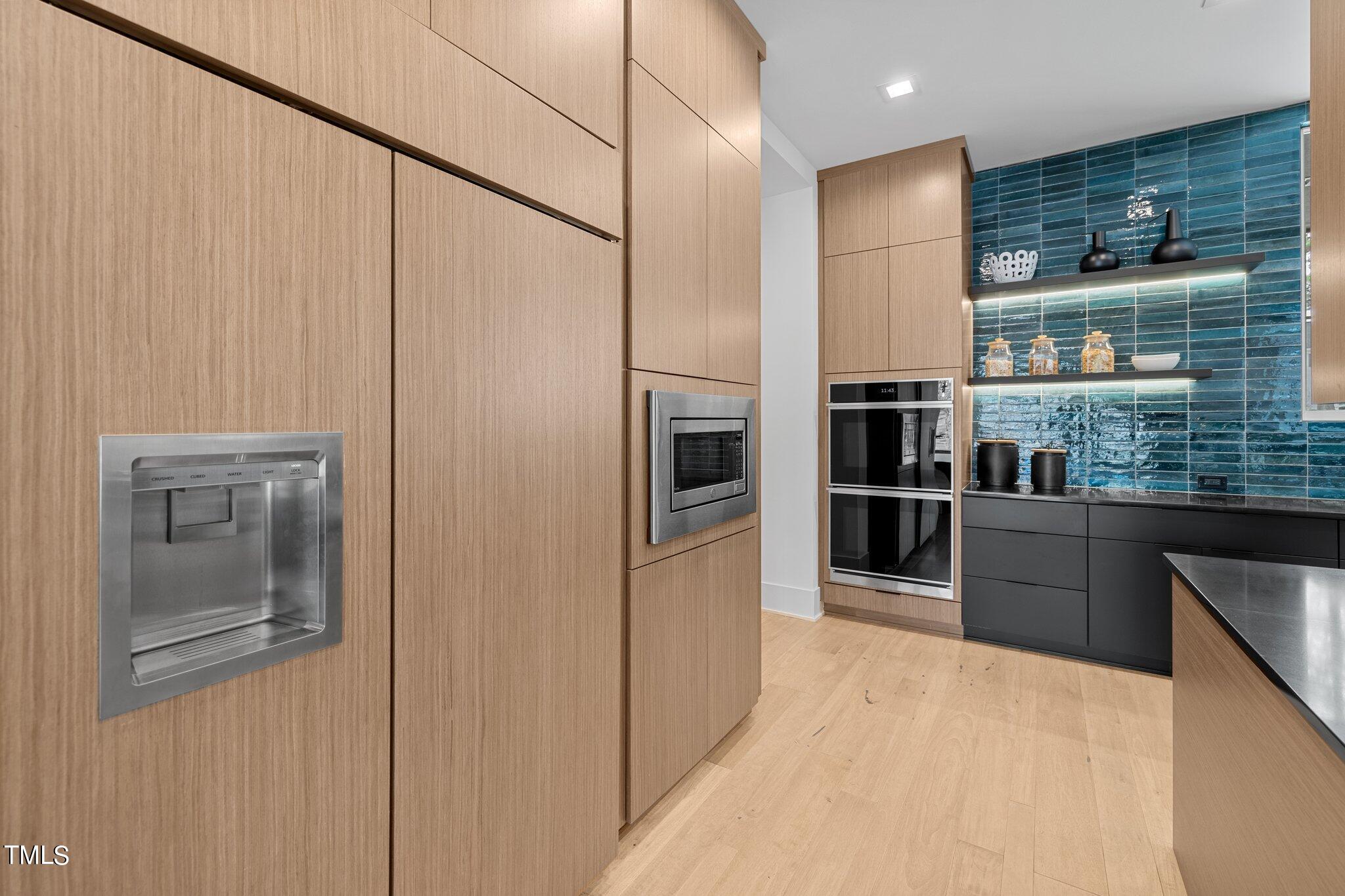 1711 Hunting Ridge Road Raleigh, NC 27615 - Photo 15 of 62 a kitchen with stainless steel appliances a refrigerator and a wooden cabinets
