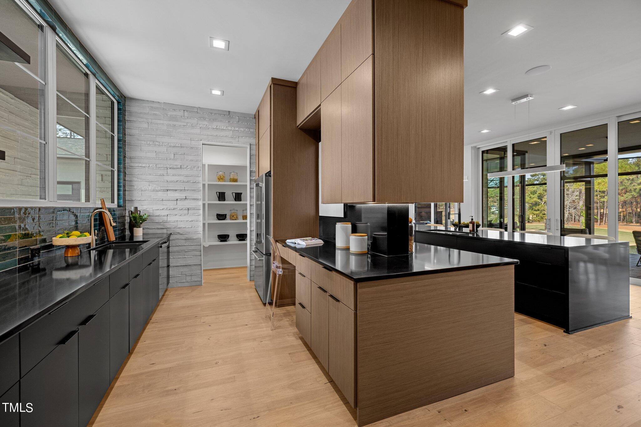 1711 Hunting Ridge Road Raleigh, NC 27615 - Photo 16 of 62 a large kitchen with stainless steel appliances kitchen island granite countertop a large counter top stainless steel appliances and cabinets