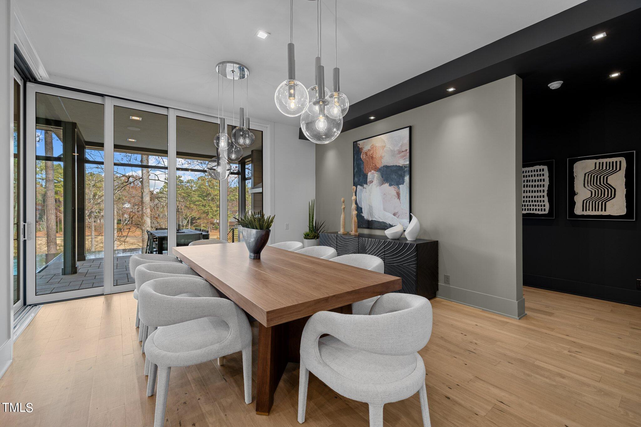 1711 Hunting Ridge Road Raleigh, NC 27615 - Photo 18 of 62 a view of a dining room with furniture window and wooden floor
