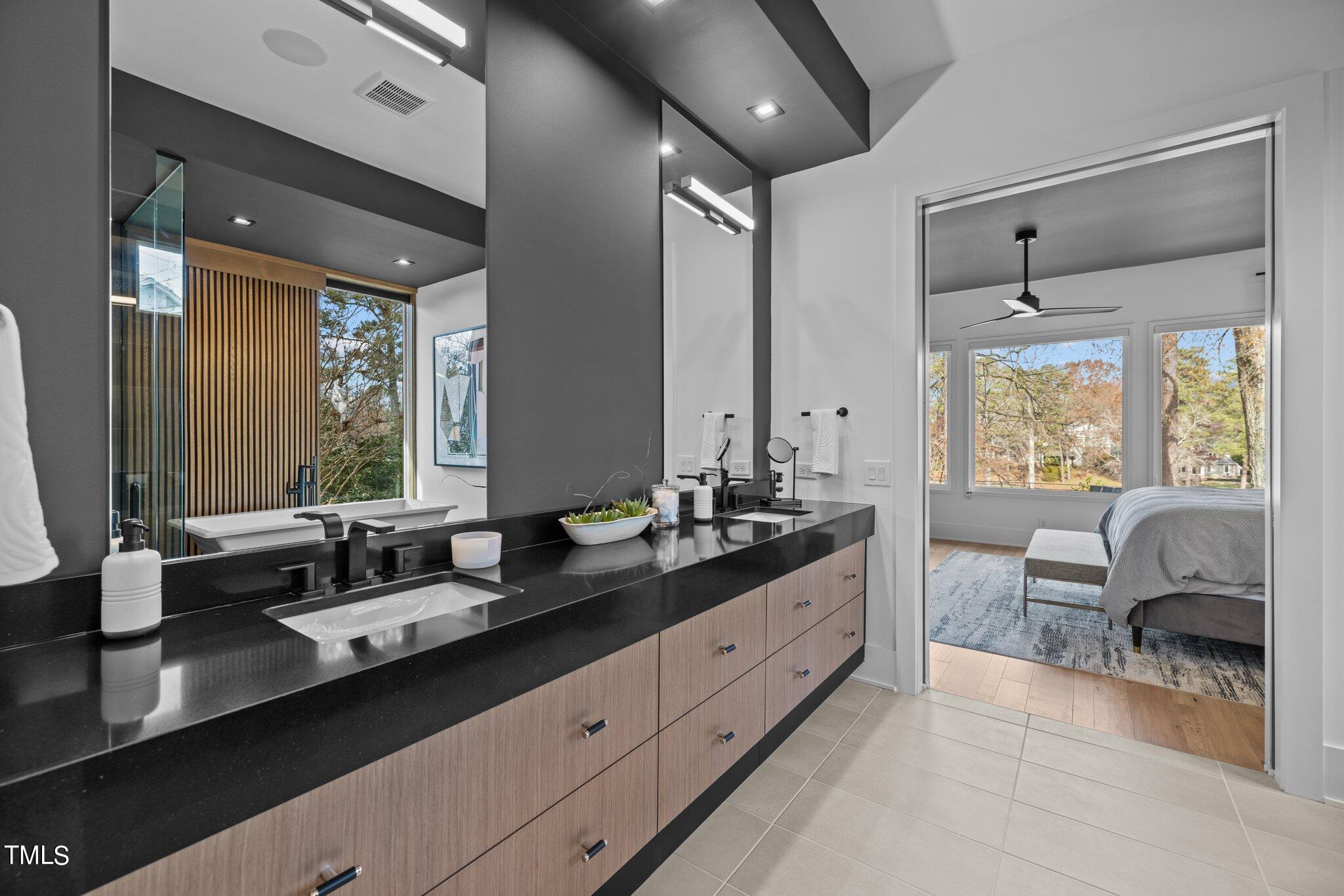 1711 Hunting Ridge Road Raleigh, NC 27615 - Photo 21 of 62 a en suite bathroom with double vanity and a mirror