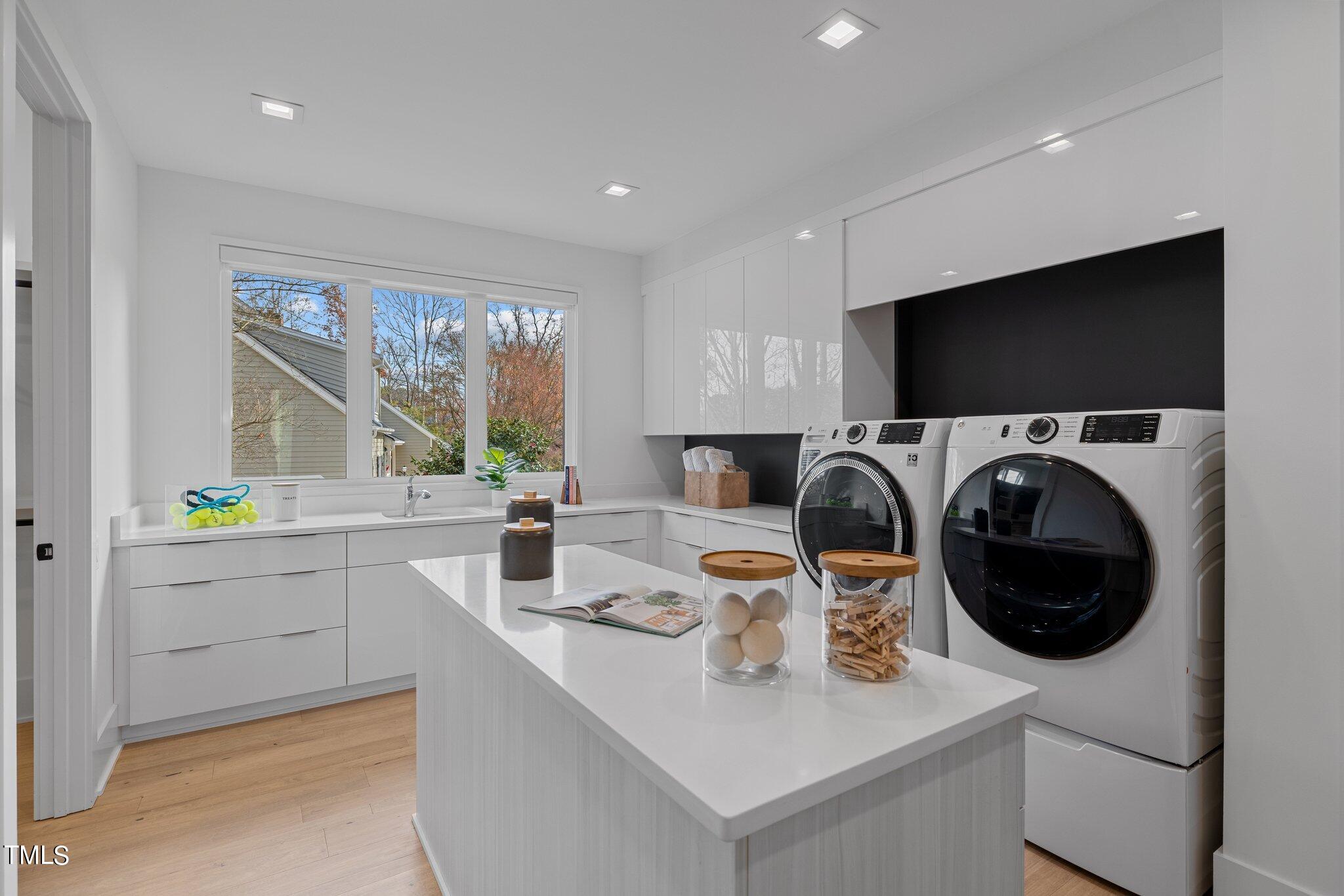 1711 Hunting Ridge Road Raleigh, NC 27615 - Photo 24 of 62 a view of a kitchen counter space with a sink a washer and dryer