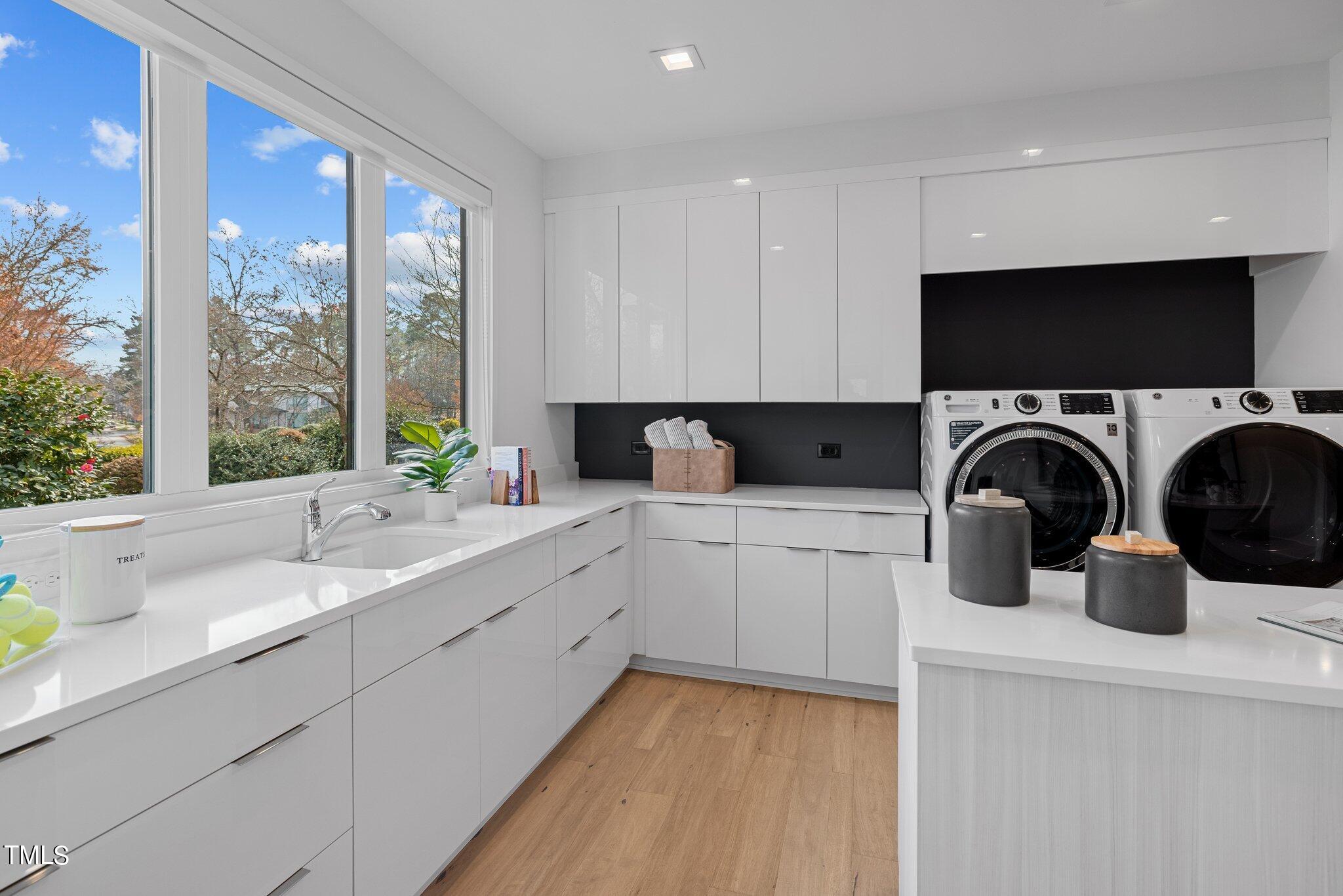 1711 Hunting Ridge Road Raleigh, NC 27615 - Photo 25 of 62 a kitchen with a sink a stove a microwave and cabinets