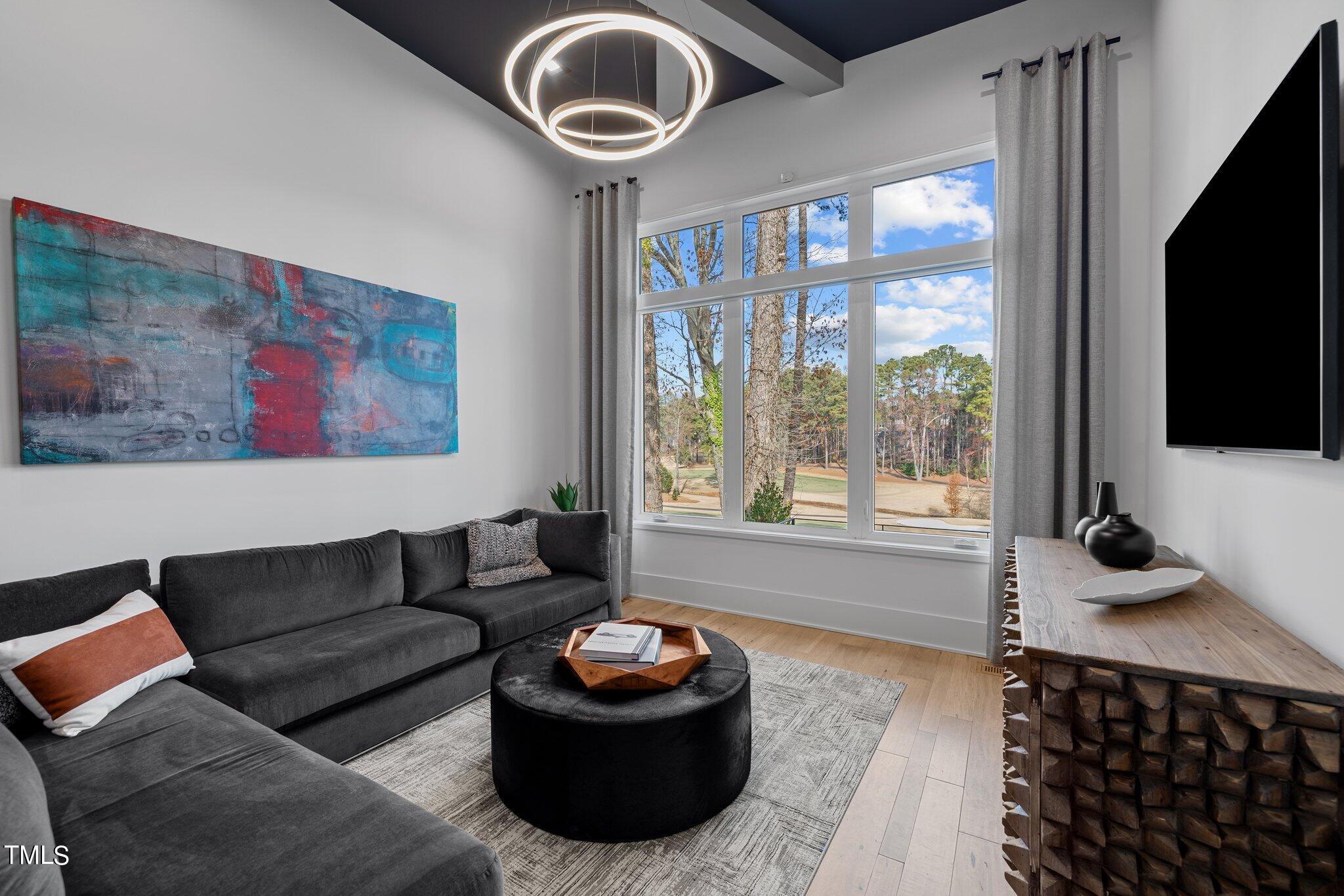 1711 Hunting Ridge Road Raleigh, NC 27615 - Photo 27 of 62 a living room with furniture and a flat screen tv
