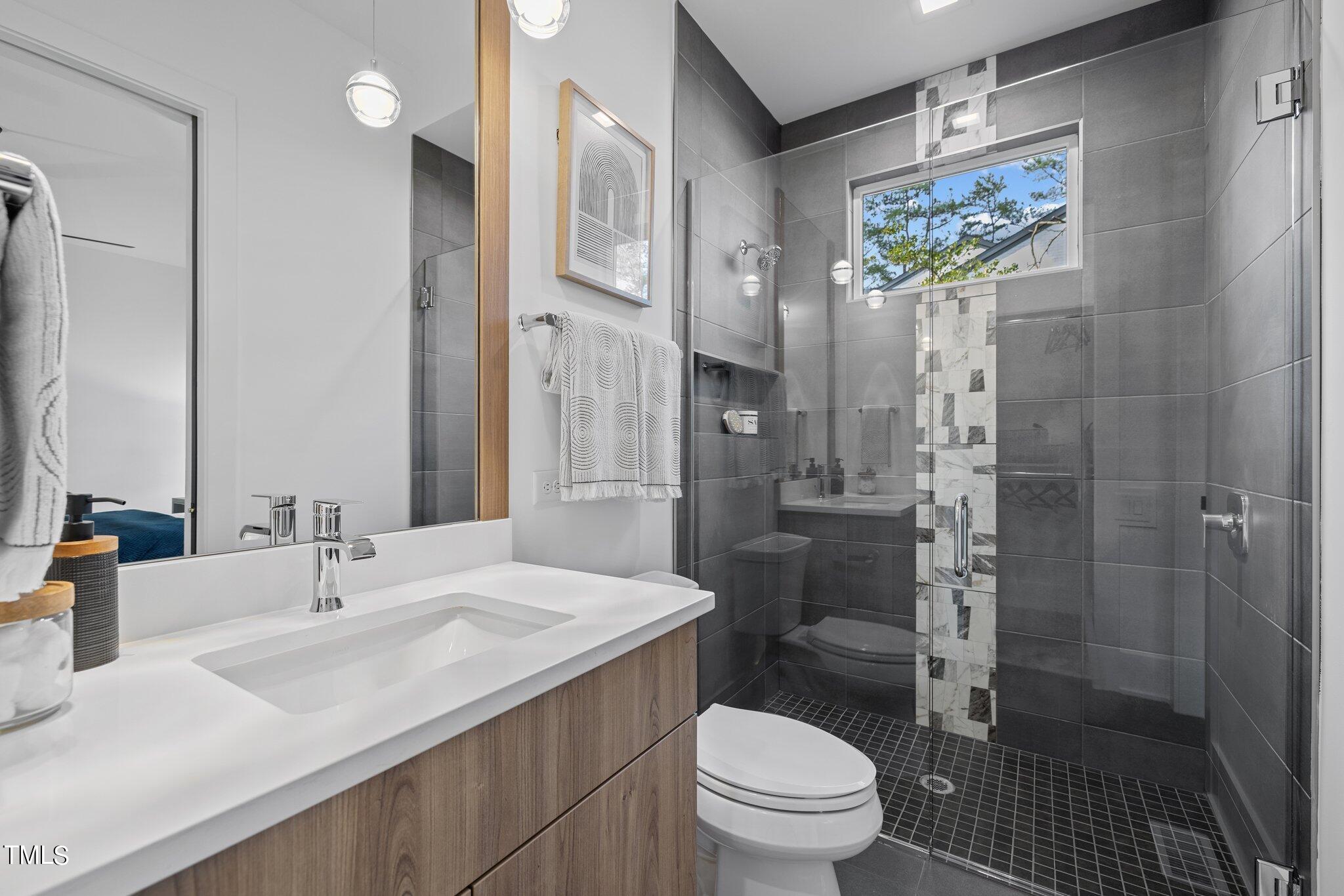 1711 Hunting Ridge Road Raleigh, NC 27615 - Photo 30 of 62 a bathroom with a sink toilet and shower