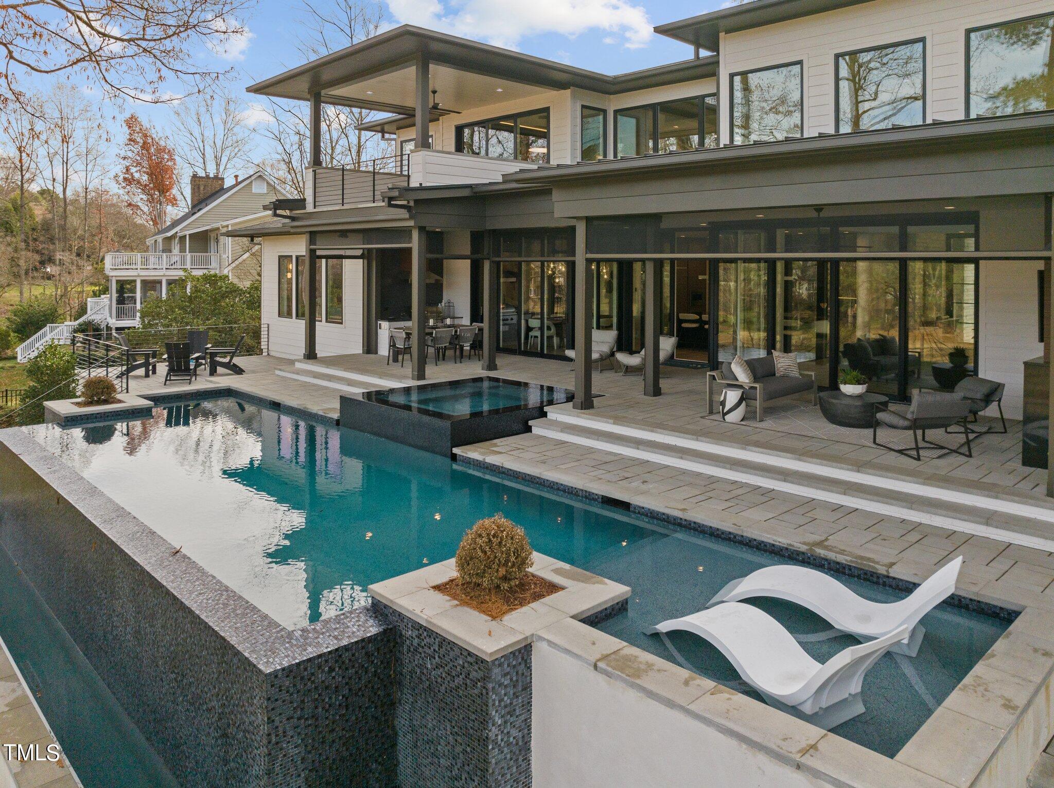 1711 Hunting Ridge Road Raleigh, NC 27615 - Photo 3 of 62 a front view of a house with swimming pool table and chairs