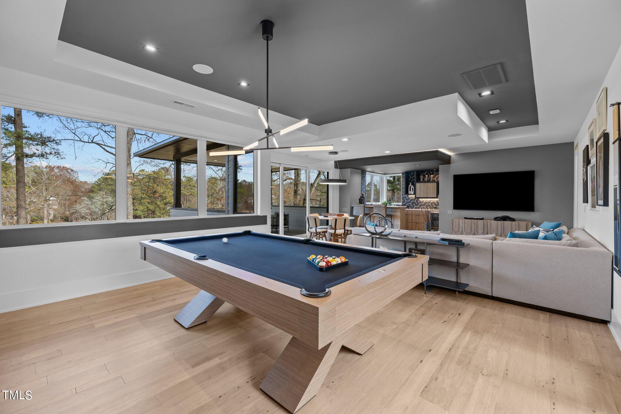 1711 Hunting Ridge Road Raleigh, NC 27615 - Photo 33 of 62 a living room with furniture a flat screen tv and a large window