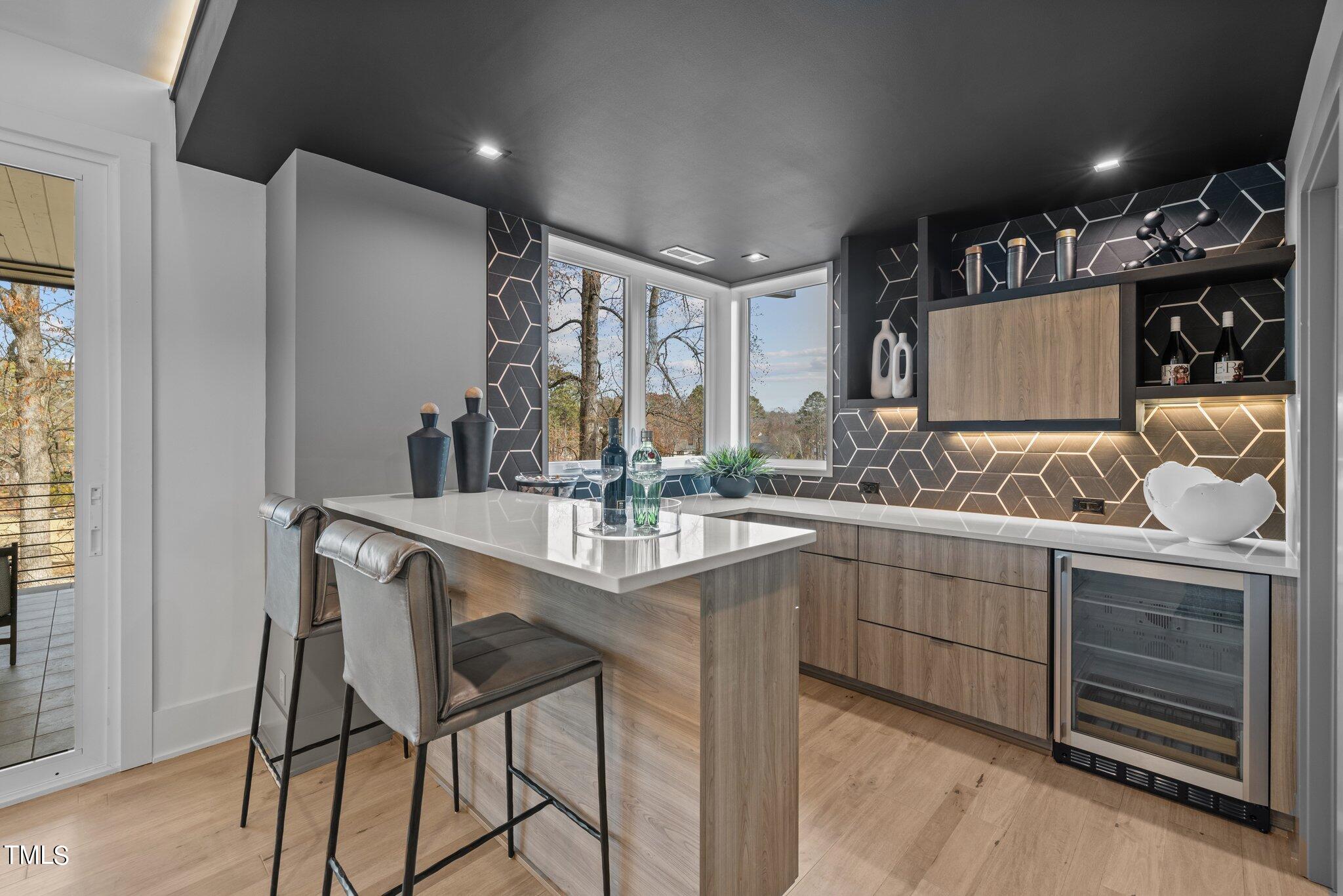 1711 Hunting Ridge Road Raleigh, NC 27615 - Photo 35 of 62 a kitchen with granite countertop white cabinets and chairs