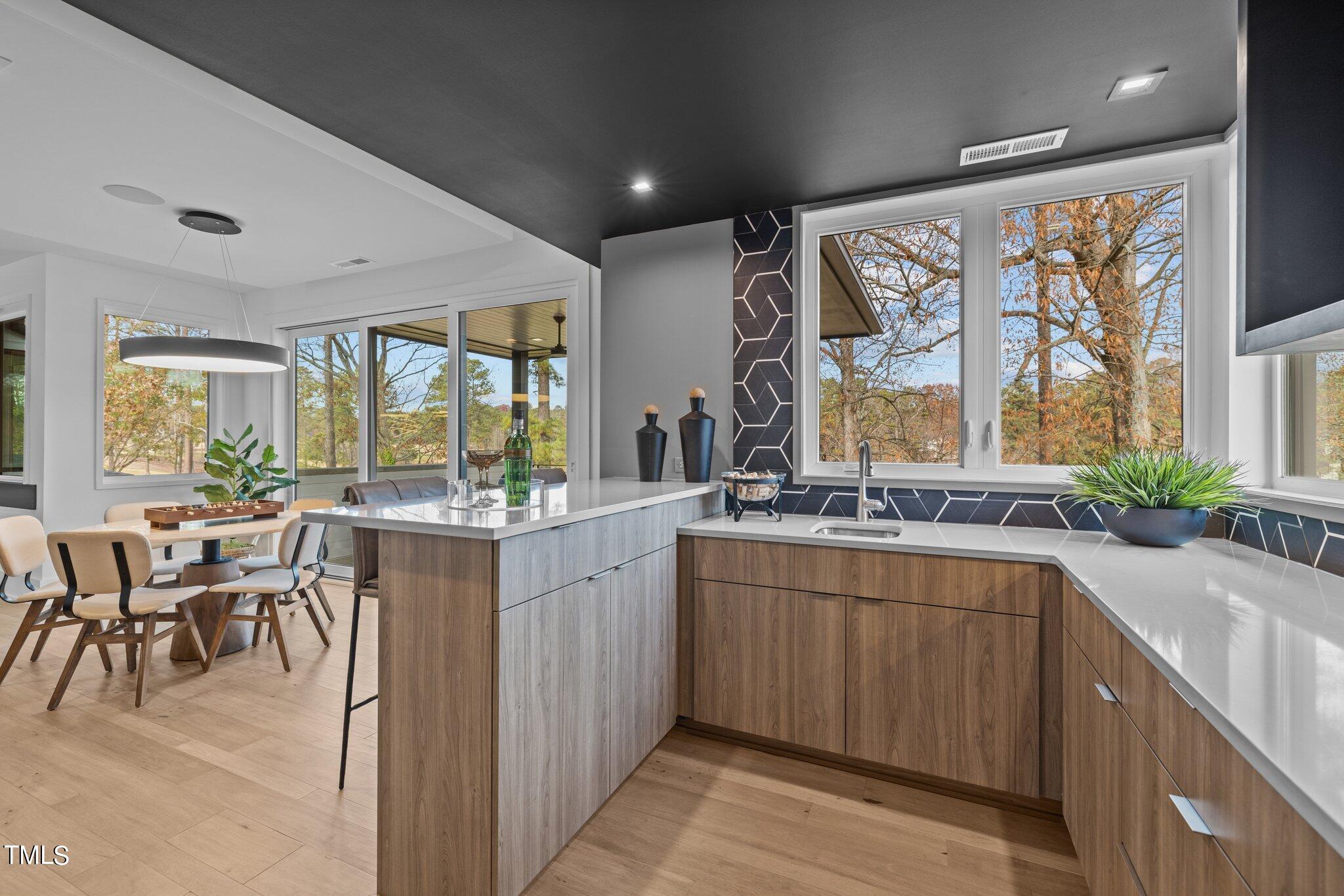 1711 Hunting Ridge Road Raleigh, NC 27615 - Photo 36 of 62 a large kitchen with a large window and table