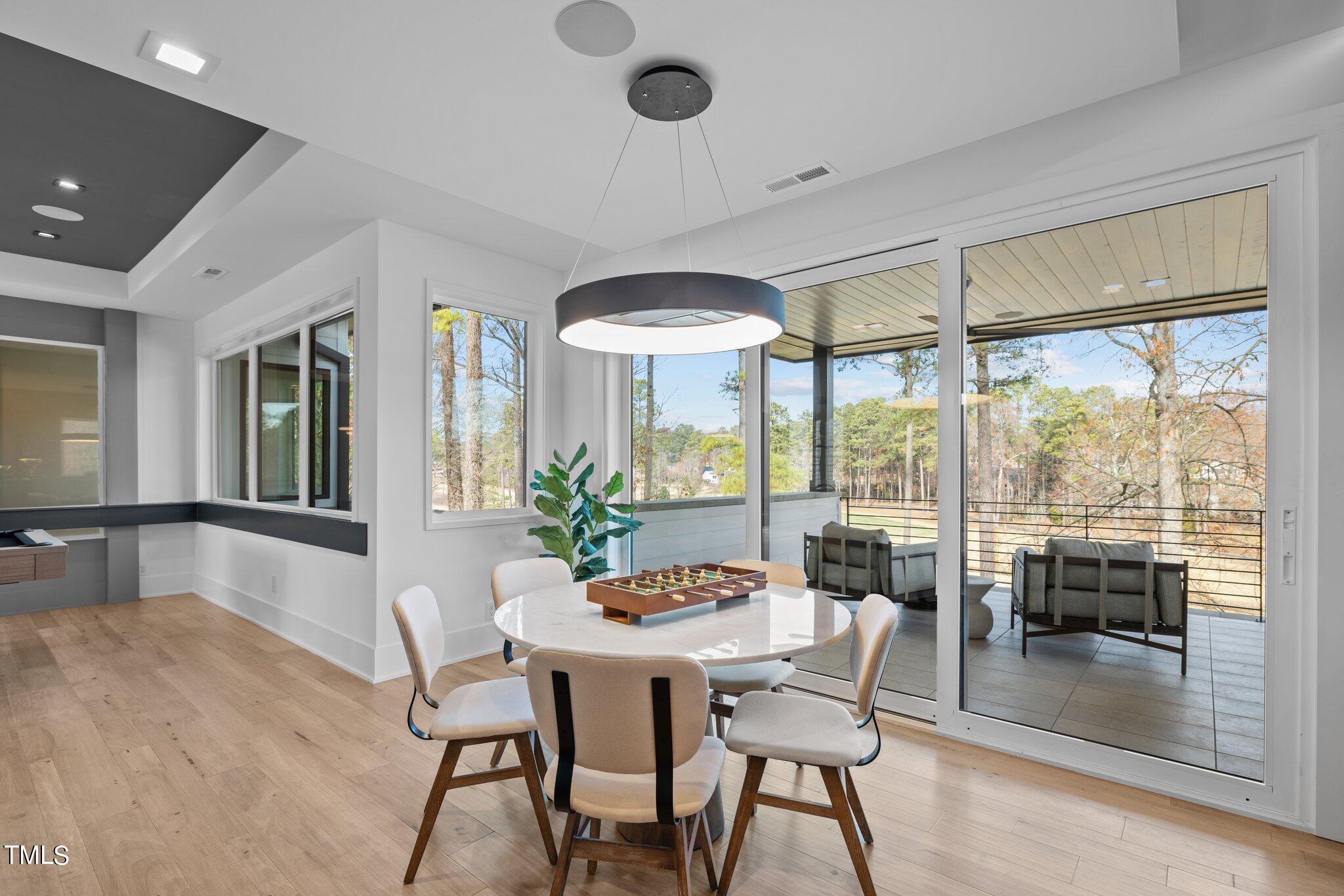 1711 Hunting Ridge Road Raleigh, NC 27615 - Photo 37 of 62 a dining room with furniture window and wooden floor