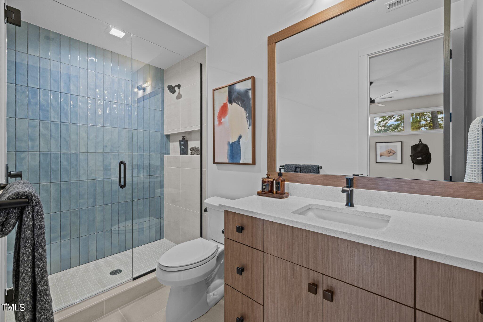 1711 Hunting Ridge Road Raleigh, NC 27615 - Photo 40 of 62 a bathroom with a sink a toilet and shower