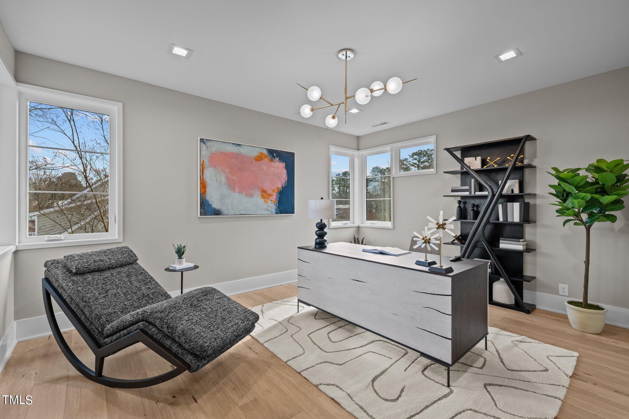 1711 Hunting Ridge Road Raleigh, NC 27615 - Photo 43 of 62 a living room with furniture and a chandelier