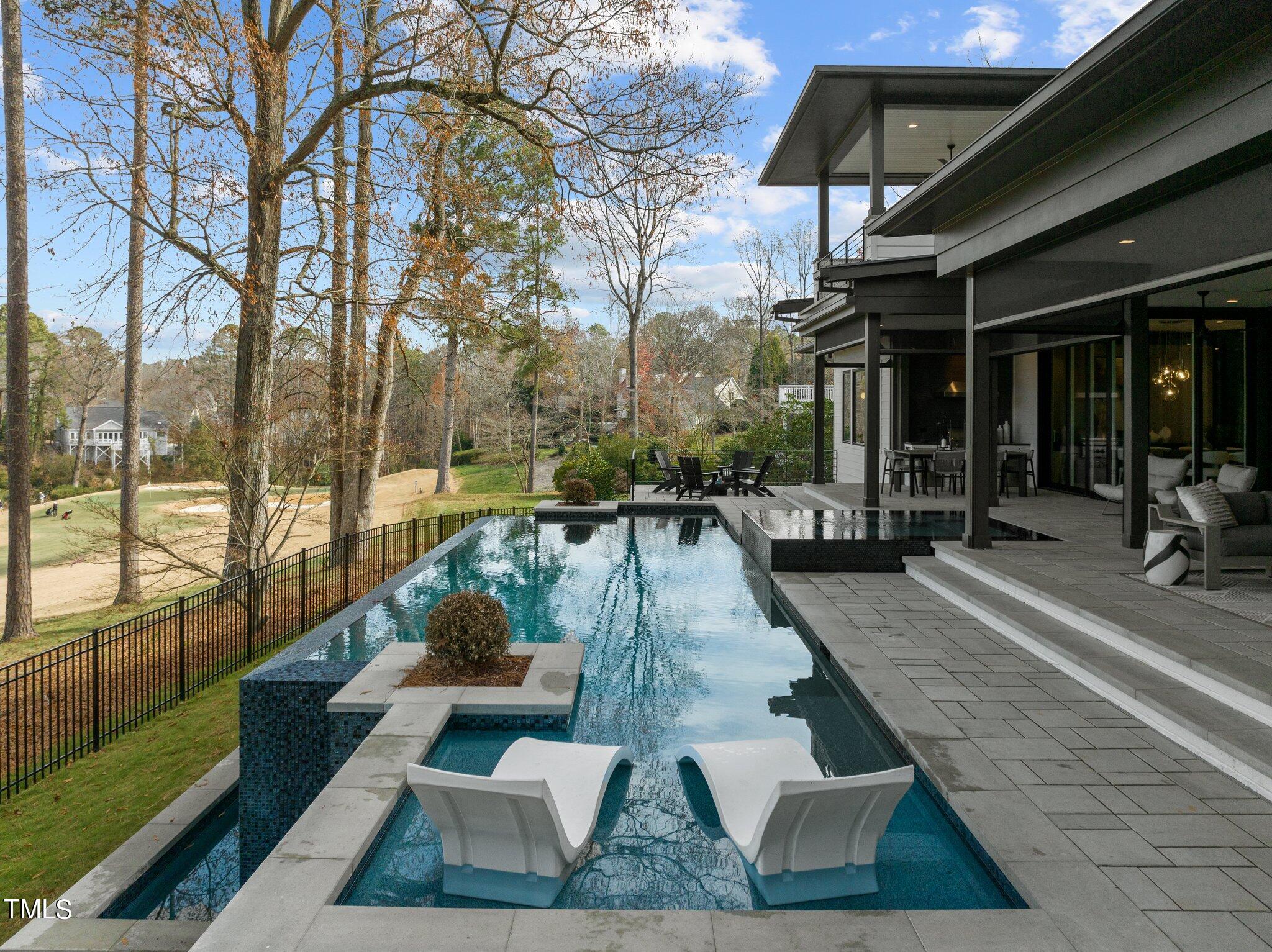 1711 Hunting Ridge Road Raleigh, NC 27615 - Photo 53 of 62 a view of a patio with table and chairs potted plants with wooden floor and fence