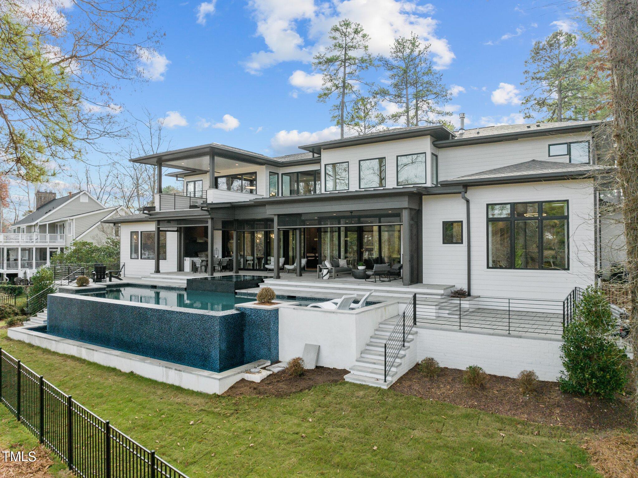 1711 Hunting Ridge Road Raleigh, NC 27615 - Photo 54 of 62 a view of a house with pool fire pit and chairs in a patio