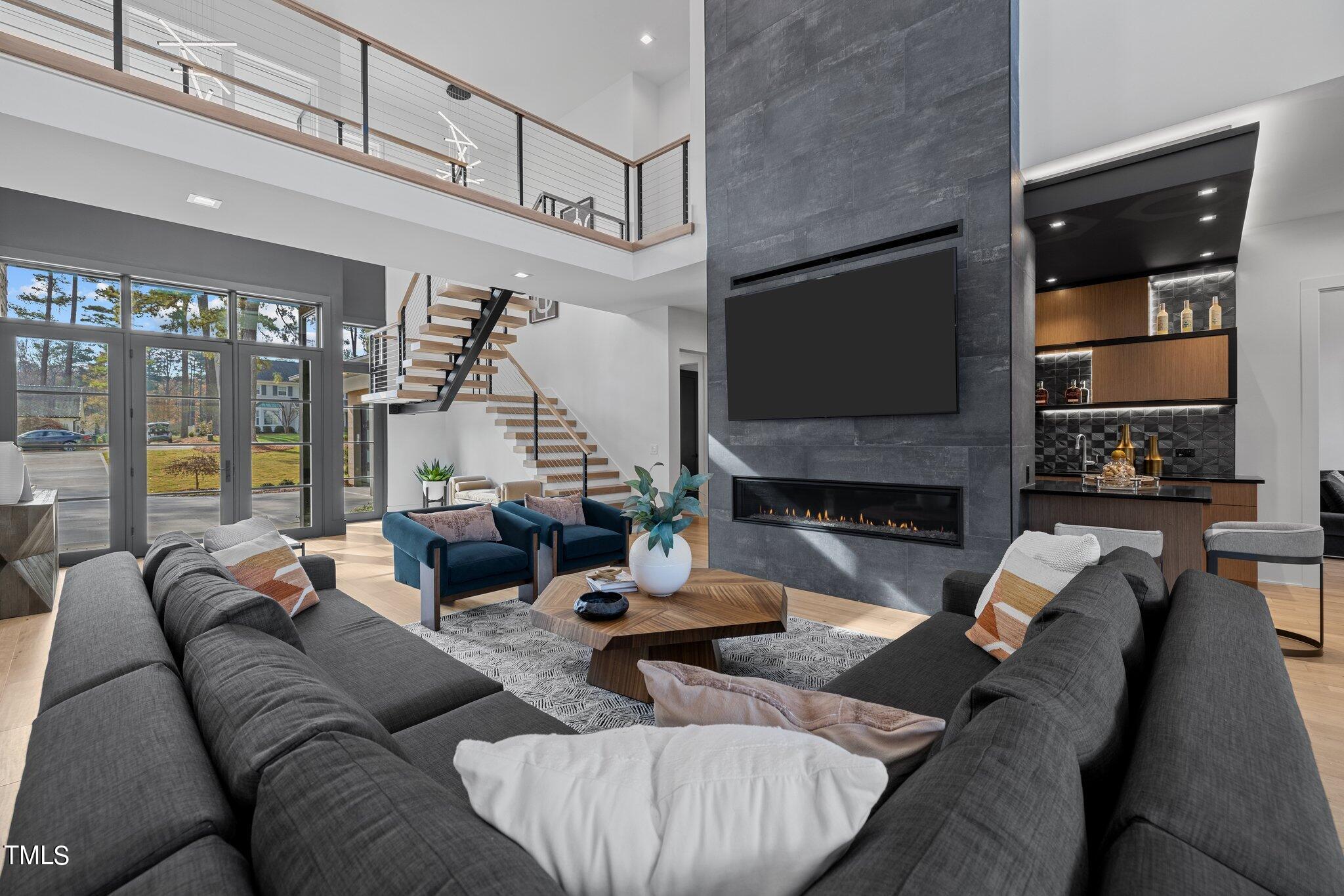 1711 Hunting Ridge Road Raleigh, NC 27615 - Photo 8 of 62 a living room with fireplace furniture and a flat screen tv