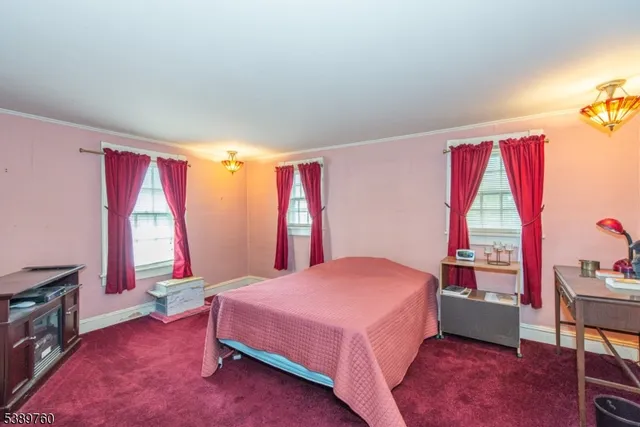 a view of a house with a yard and large tree