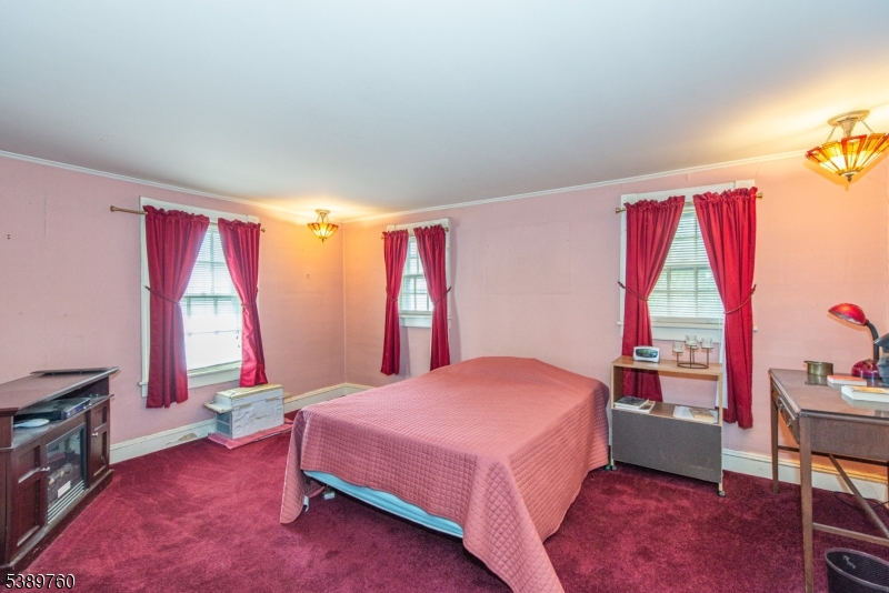 570 Mine Brook Road Bernardsville, NJ 07924 - Photo 20 of 36 a bedroom with a bed and a window