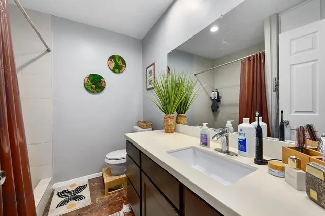 a kitchen that has a lot of cabinets a sink and appliances in it