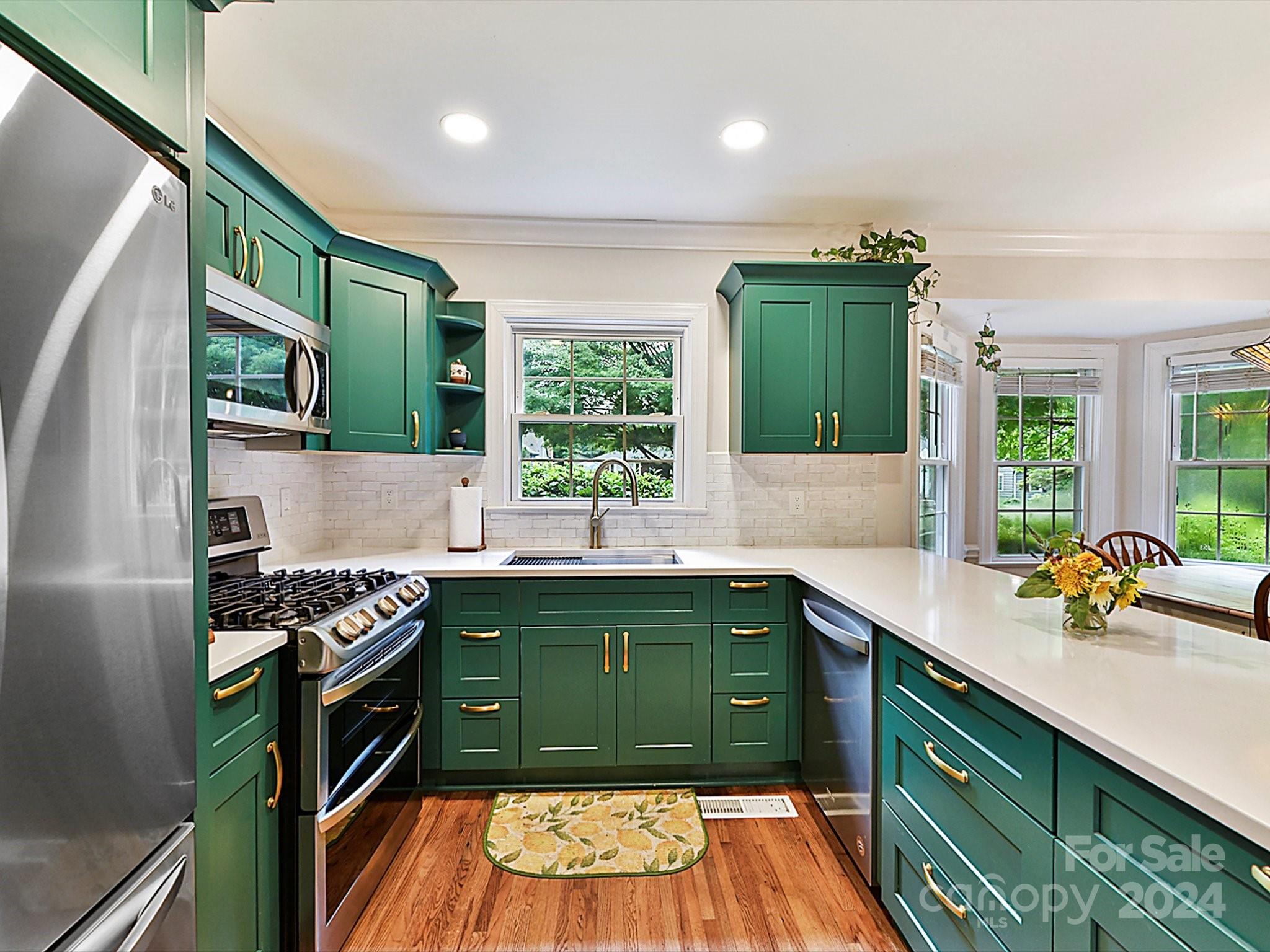 1309 Morningside Drive Charlotte, NC 28205 - Photo 12 of 41 a kitchen with kitchen island a sink stove and cabinets