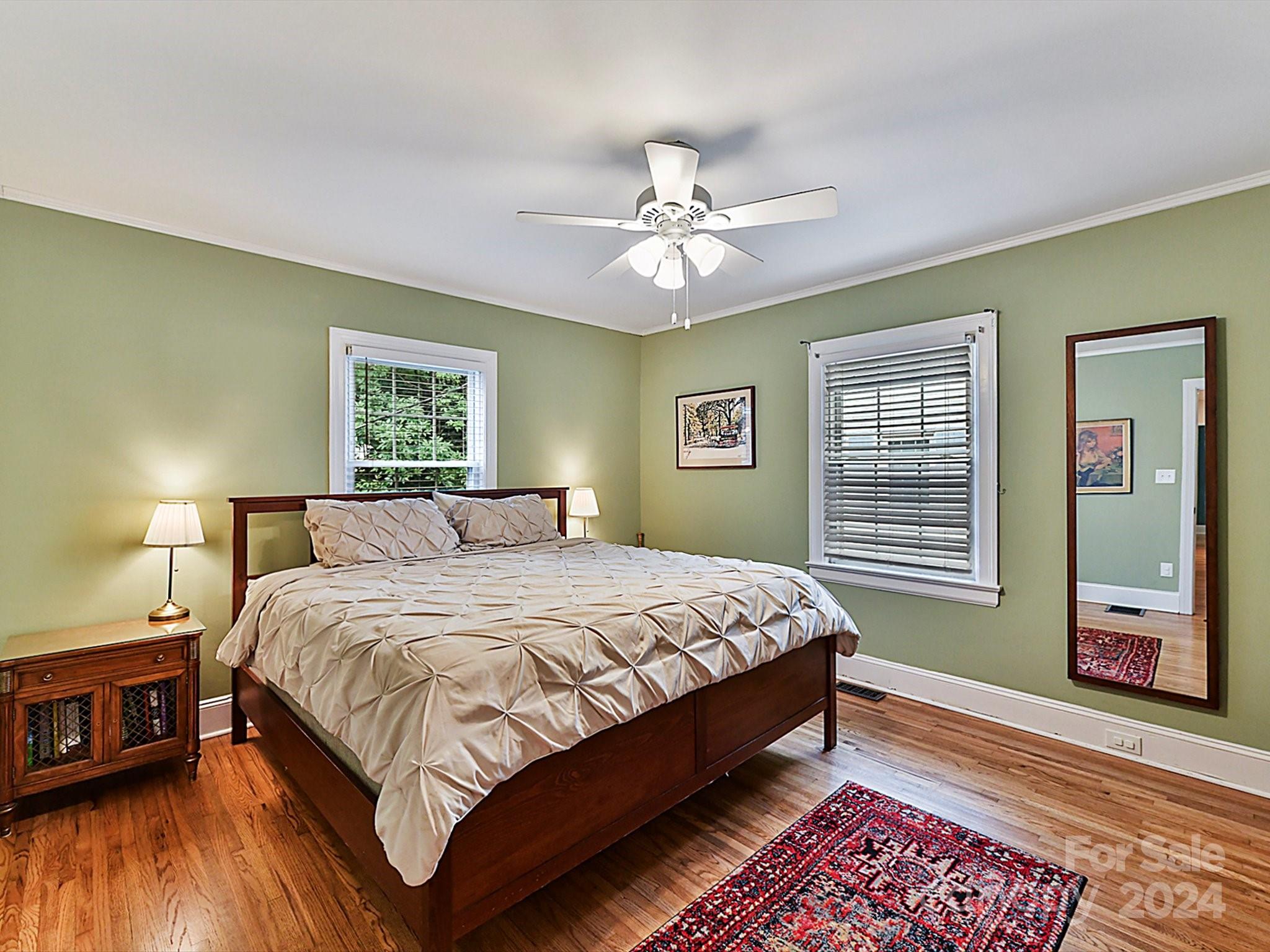 1309 Morningside Drive Charlotte, NC 28205 - Photo 17 of 41 a bedroom with a large bed and a chandelier