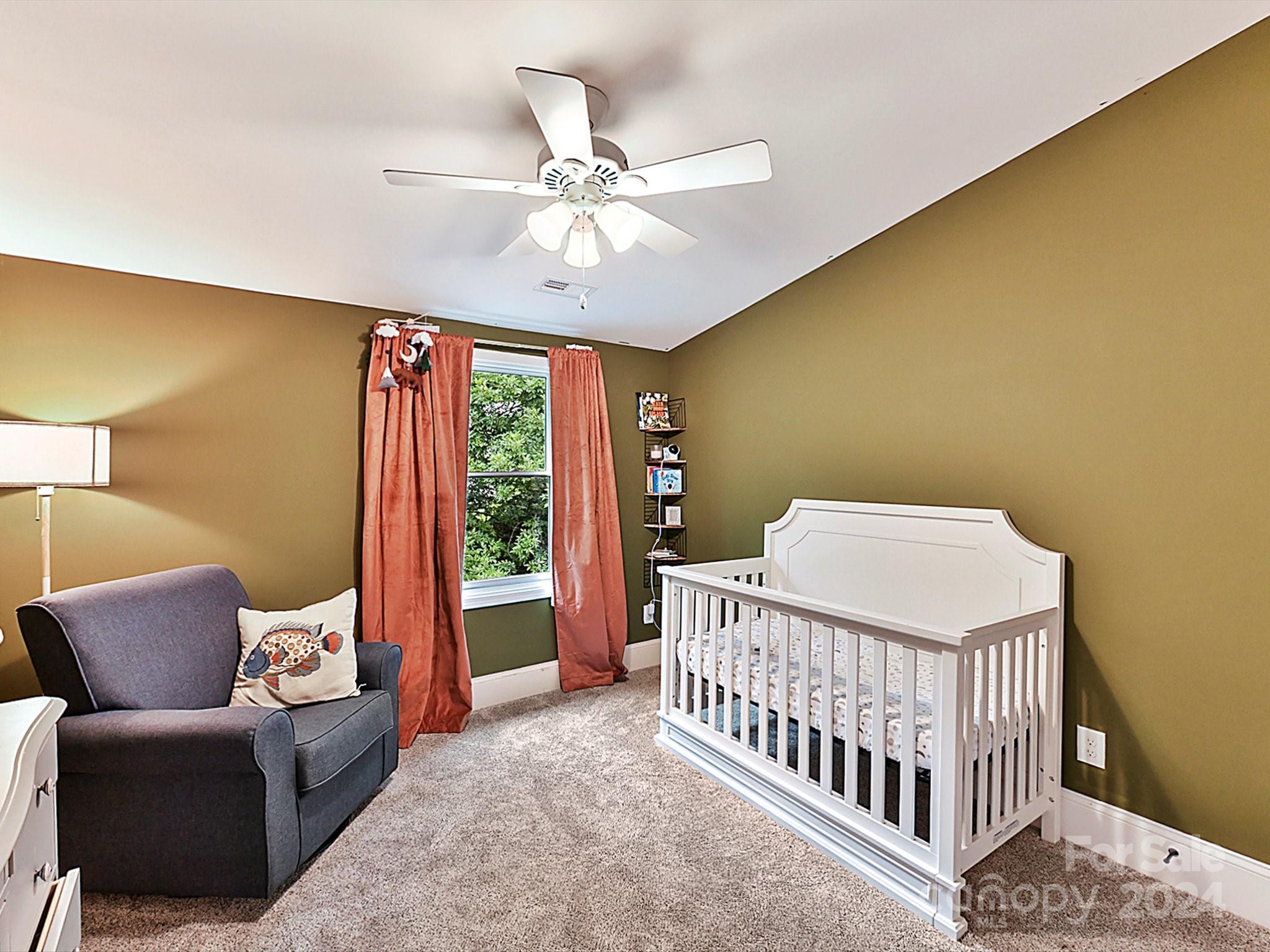 1309 Morningside Drive Charlotte, NC 28205 - Photo 25 of 41 a bedroom with a bed and a chandelier
