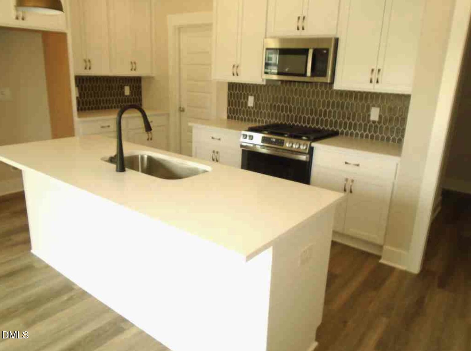3918 Willow Gate Way Raleigh, NC 27604 - Photo 3 of 3 a kitchen with a sink a stove and cabinets