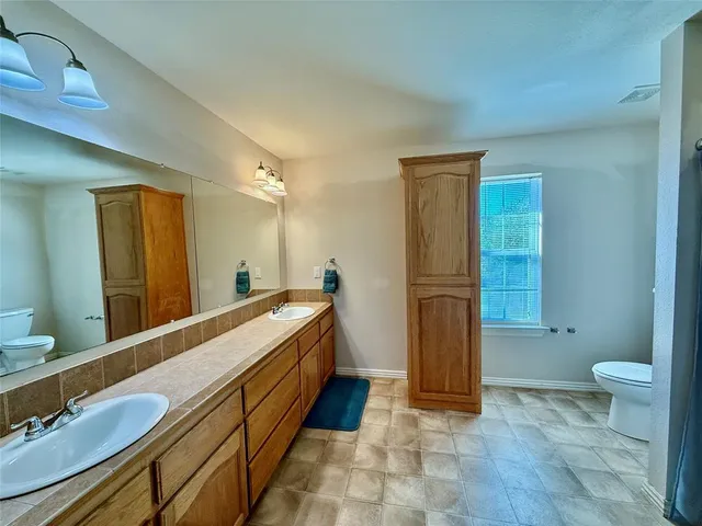 a bathroom with a double vanity sink and a mirror