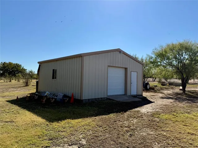 a view of backyard with seating area and barbeque oven