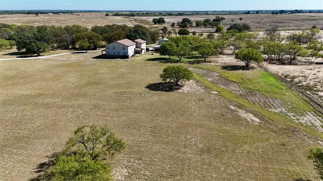 an aerial view of a houses with a yard