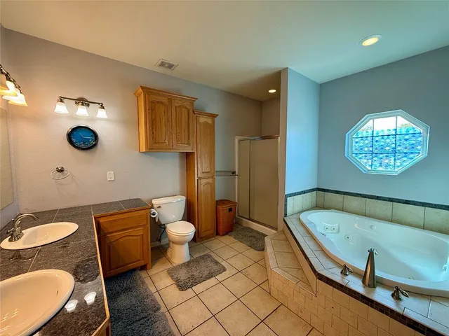 a bathroom with a sink mirror and toilet