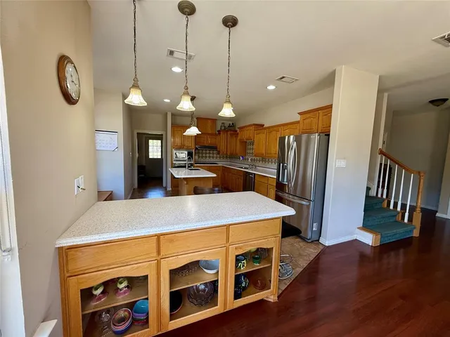 a kitchen with a stove and a wooden floor