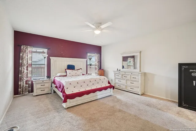 a spacious bedroom with a bed and a desk