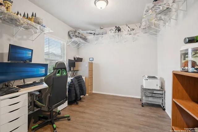 a view of workspace with wooden floor windows
