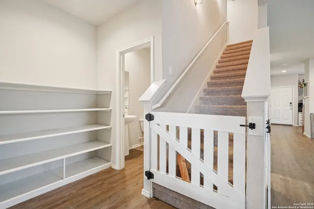 a view of staircase with white walls and a window