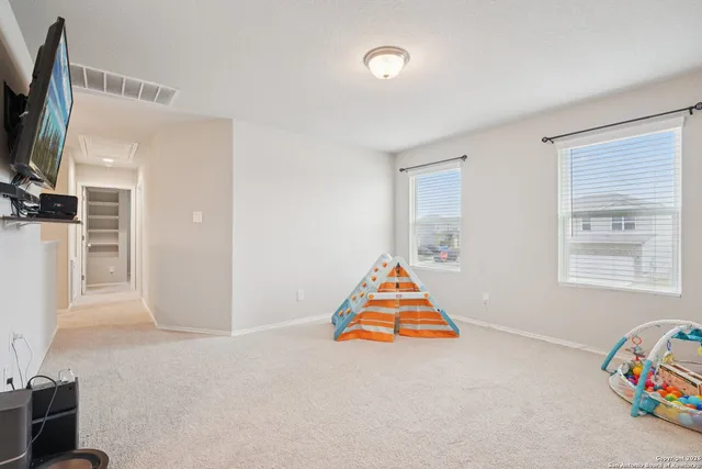 a room with furniture and a flat screen tv