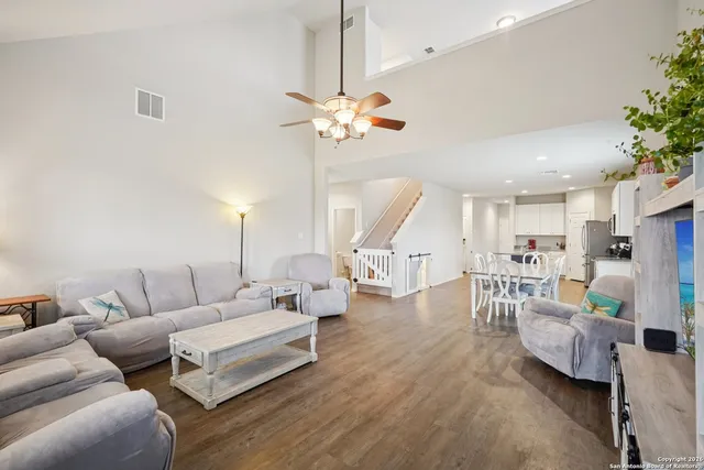 a living room with furniture a fireplace and a potted plant